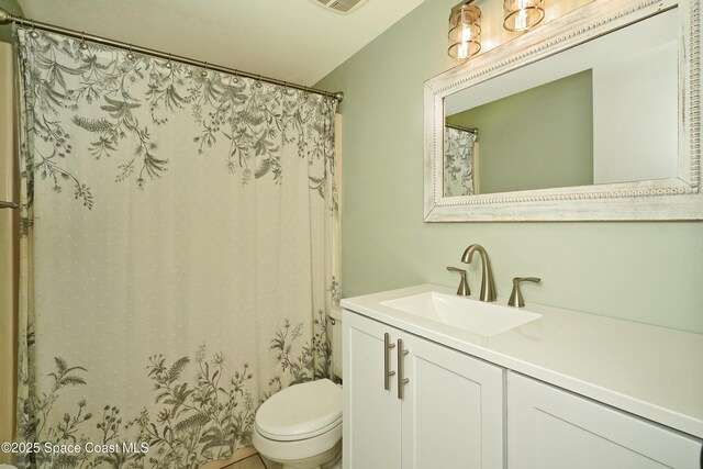 bathroom featuring visible vents, vanity, toilet, and a shower with curtain