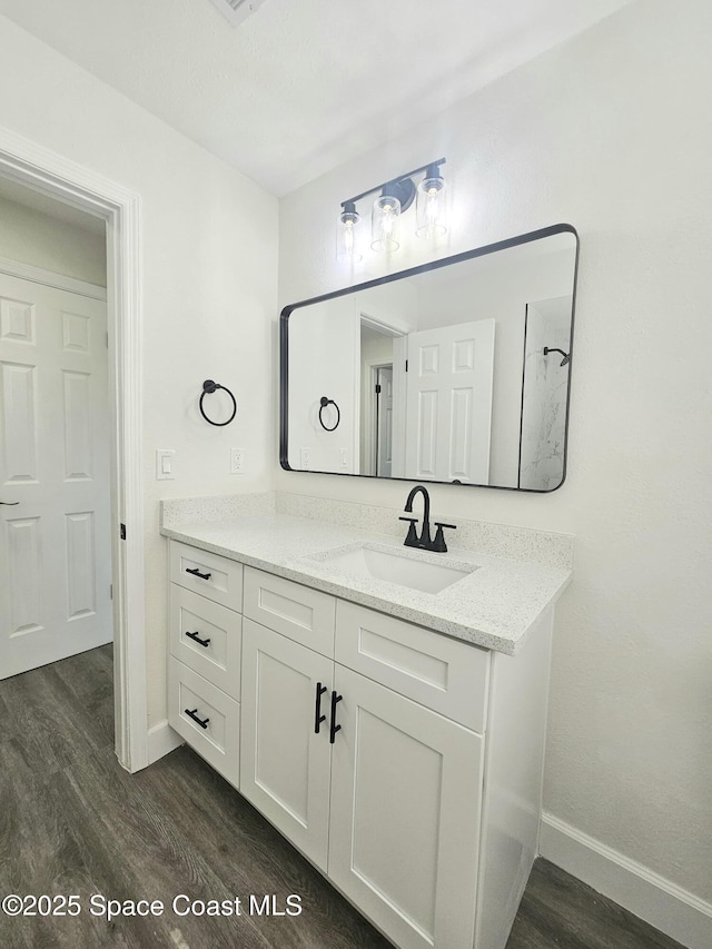 bathroom with vanity and hardwood / wood-style floors