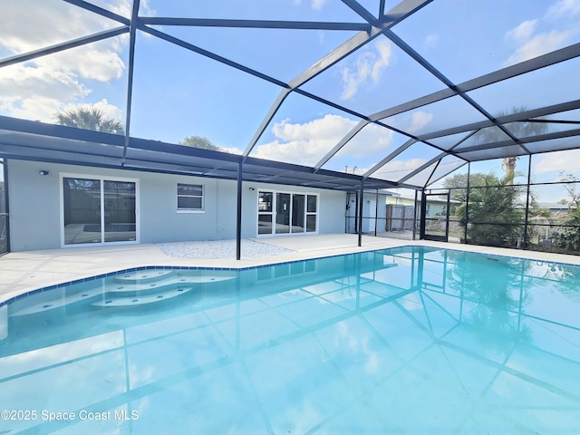 view of swimming pool featuring a lanai and a patio area