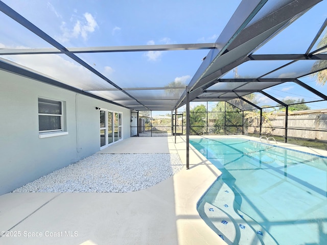 view of swimming pool featuring a patio and a lanai