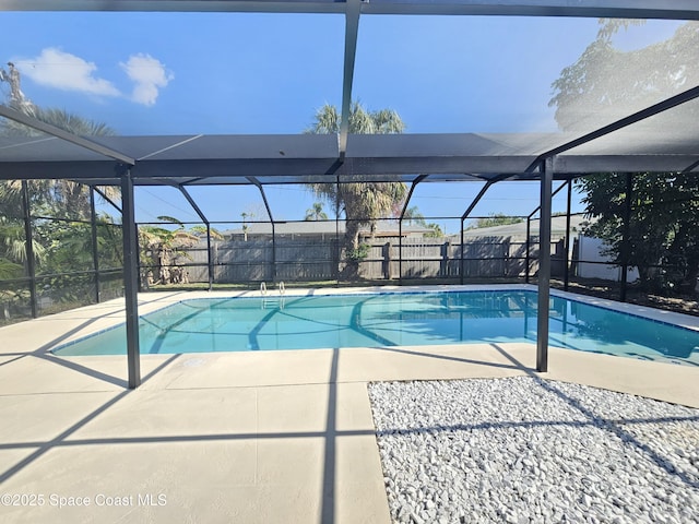 view of pool featuring a patio and glass enclosure