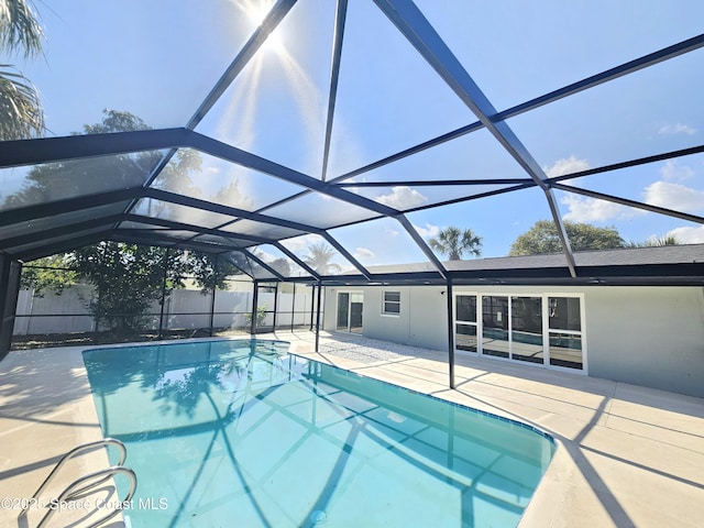 view of swimming pool with a patio and a lanai