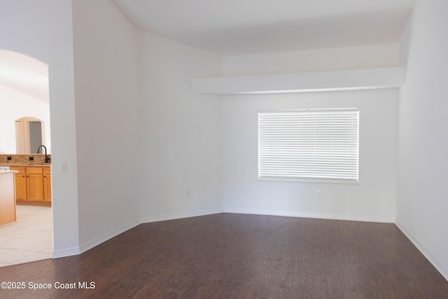 empty room featuring sink and light hardwood / wood-style flooring