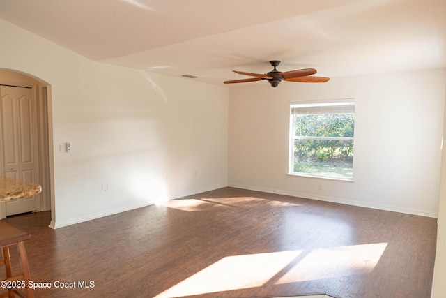 spare room featuring ceiling fan and dark hardwood / wood-style flooring