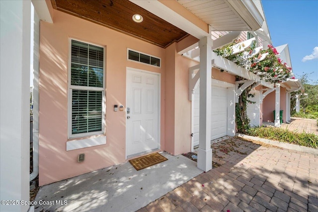 view of exterior entry with a garage