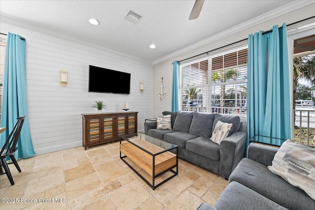 living room featuring crown molding, ceiling fan, and plenty of natural light