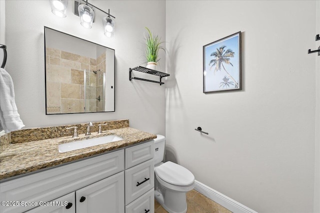 bathroom with vanity, tile patterned flooring, toilet, and walk in shower