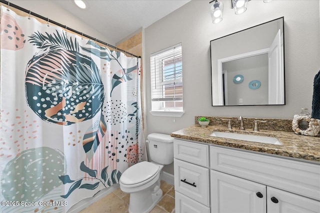 bathroom with vanity, tile patterned floors, and toilet