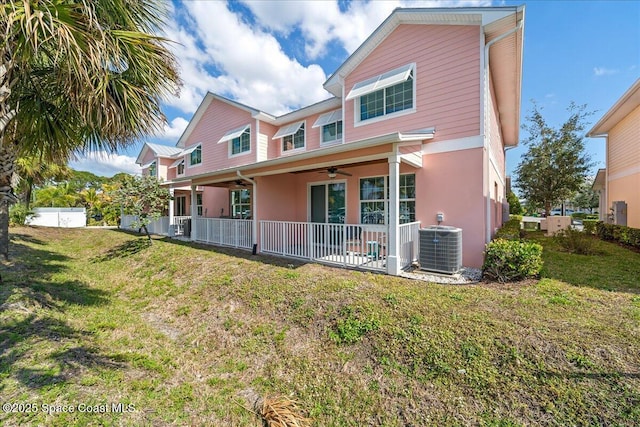 rear view of property with covered porch, a lawn, ceiling fan, and central air condition unit