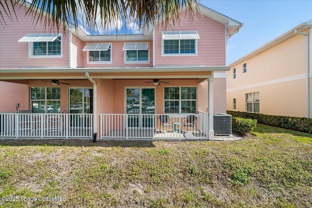 view of front of house with a front lawn, ceiling fan, and central air condition unit