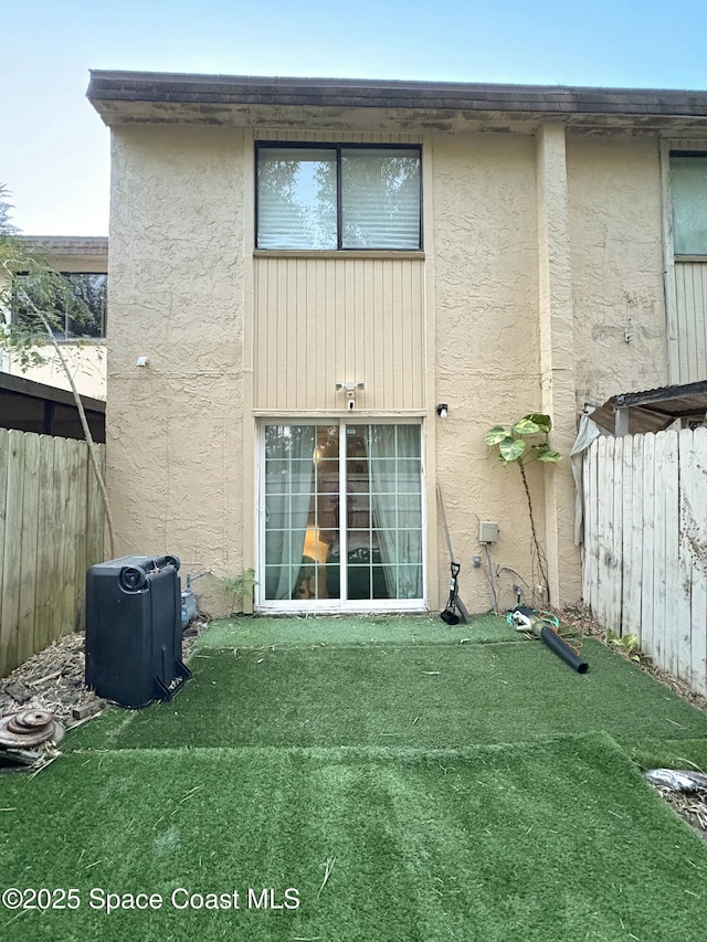 rear view of house with a yard