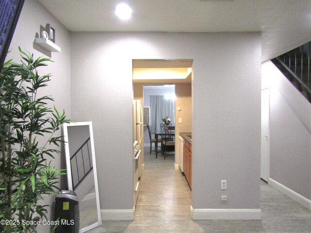 hallway with light hardwood / wood-style flooring