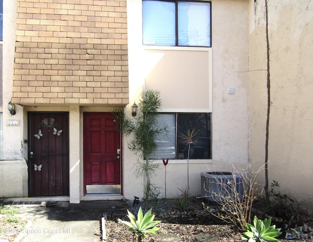 view of exterior entry with central air condition unit