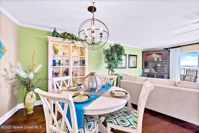 dining area featuring ornamental molding, dark wood finished floors, and a notable chandelier