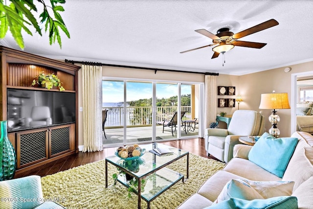 living room featuring crown molding, dark hardwood / wood-style floors, ceiling fan, and a textured ceiling