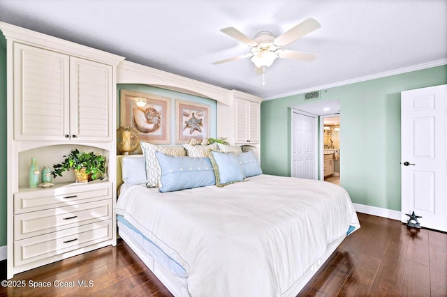 bedroom with dark hardwood / wood-style flooring, ornamental molding, and ensuite bathroom