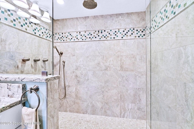 bathroom featuring vanity and a tile shower