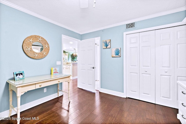 office space featuring dark hardwood / wood-style flooring, crown molding, and a textured ceiling