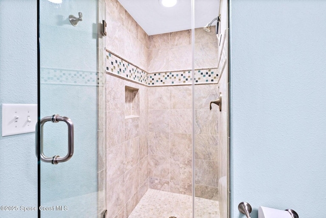 bathroom with a shower with shower door