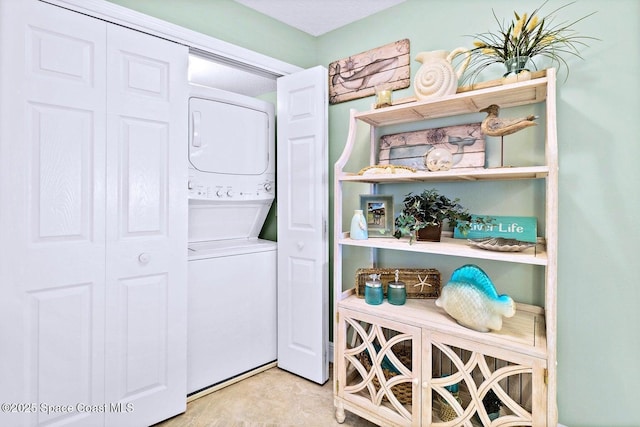 laundry room with stacked washer / dryer and laundry area