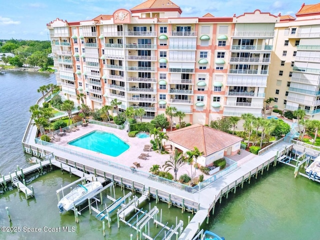 view of property with a water view and a community pool