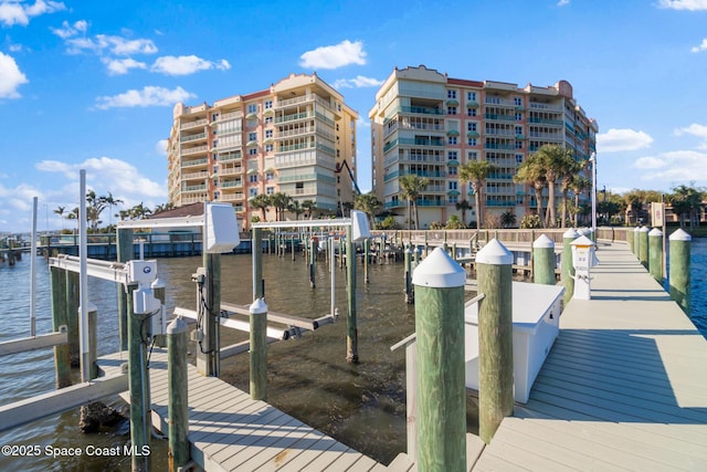 dock area with a water view and boat lift