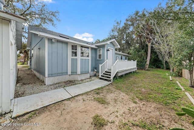 exterior space featuring a deck and a lawn