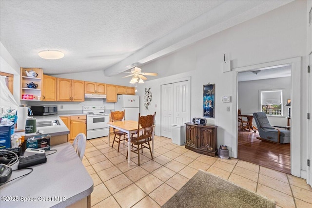 kitchen with lofted ceiling with beams, light tile patterned floors, white appliances, light brown cabinets, and a textured ceiling