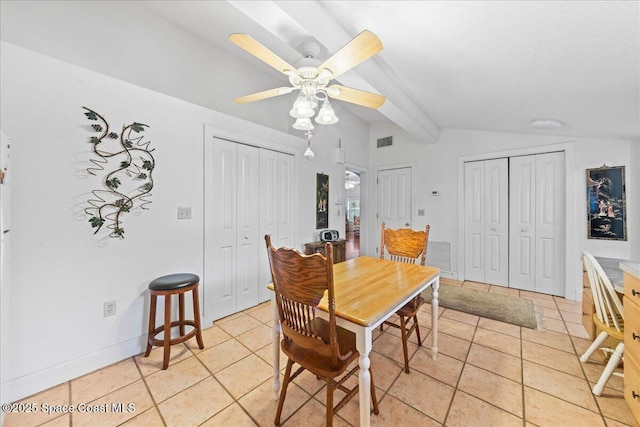 tiled dining area with vaulted ceiling with beams and ceiling fan