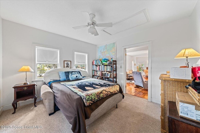 bedroom with light carpet and ceiling fan