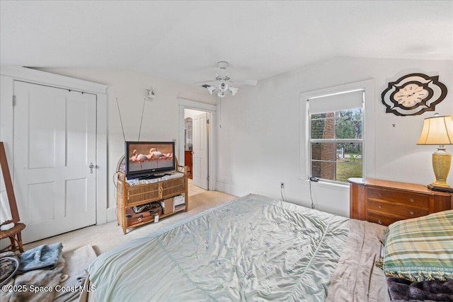 bedroom with light carpet and vaulted ceiling