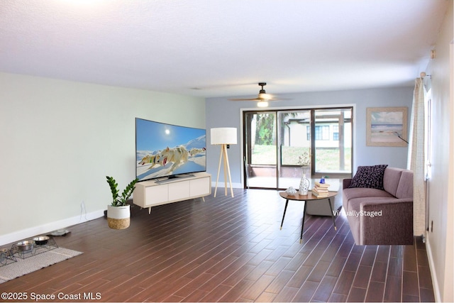 living room with dark hardwood / wood-style flooring and ceiling fan