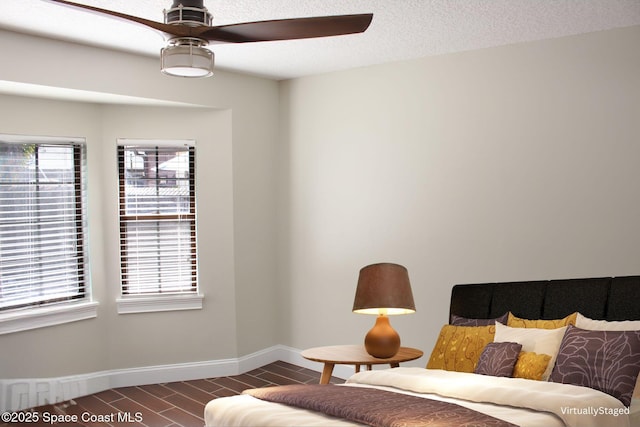 interior space featuring ceiling fan and a textured ceiling