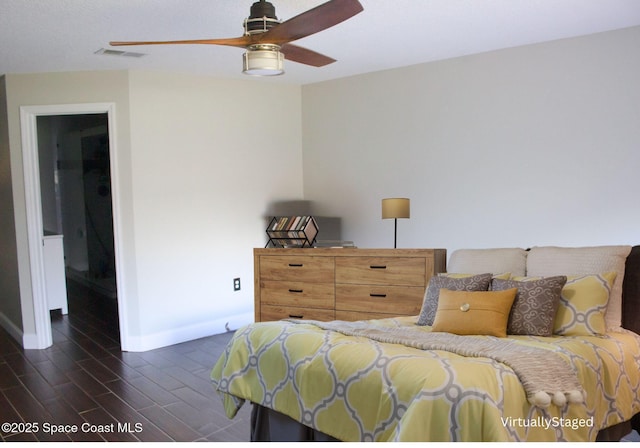 bedroom with dark hardwood / wood-style flooring and ceiling fan