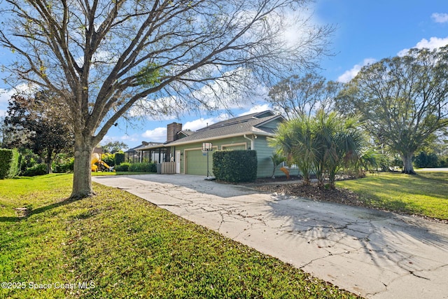 view of side of property with a garage and a lawn