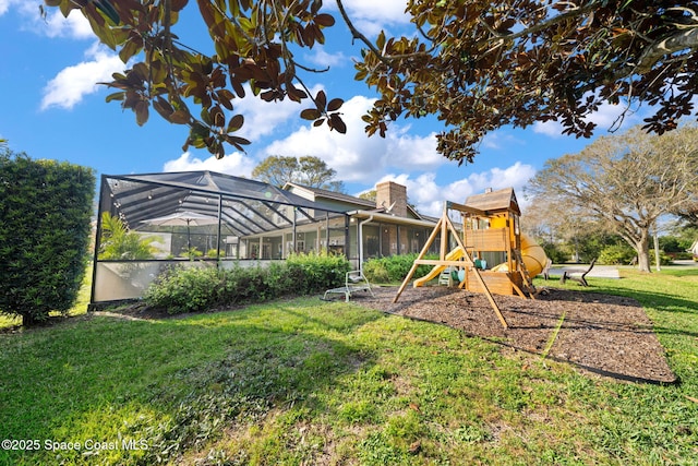 view of yard featuring a lanai and a playground