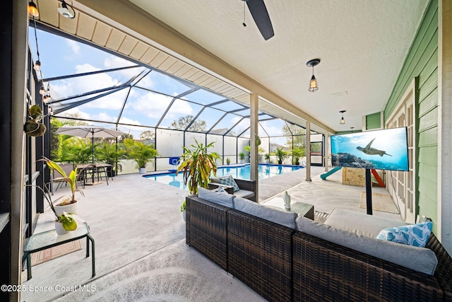 view of patio featuring outdoor lounge area and glass enclosure