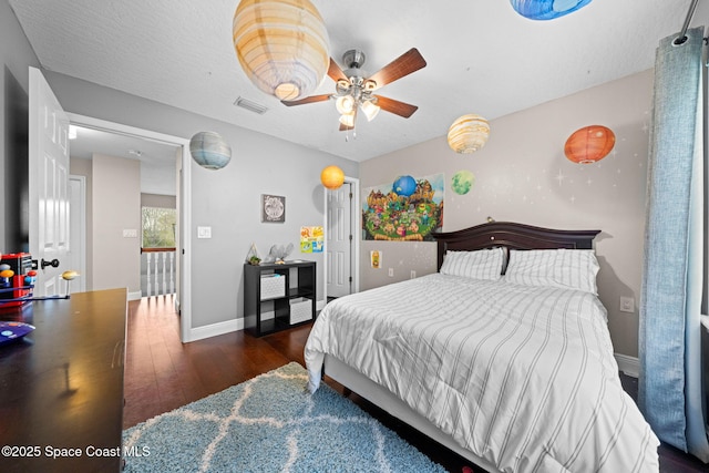 bedroom with dark hardwood / wood-style flooring and a textured ceiling