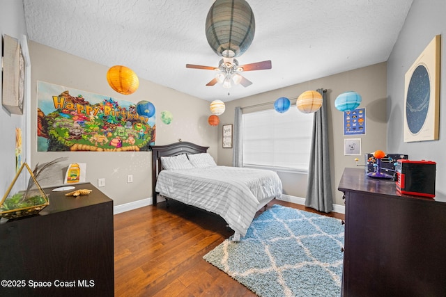 bedroom featuring dark hardwood / wood-style flooring and a textured ceiling