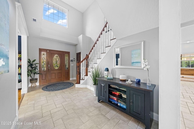 foyer featuring a towering ceiling