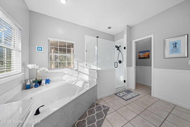 bathroom with plenty of natural light, tile patterned floors, and shower with separate bathtub