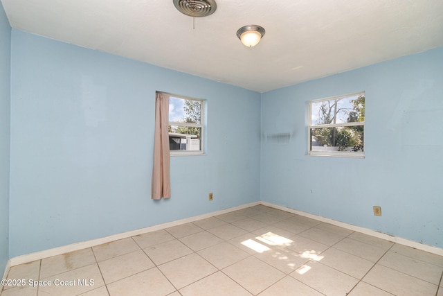 spare room featuring light tile patterned floors