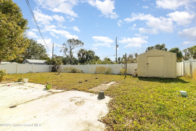 view of yard featuring a storage shed and a patio