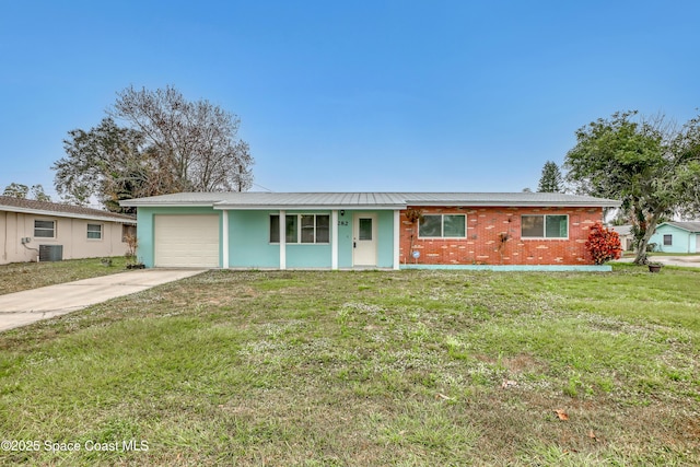 ranch-style house featuring central AC unit, a garage, and a front yard