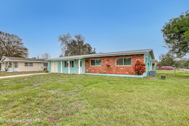 single story home featuring cooling unit and a front lawn