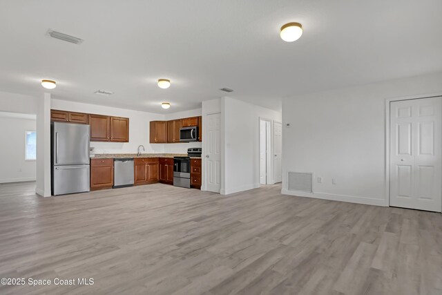 282 Hollywood Blvd, Melbourne, FL 32904 - kitchen with appliances with stainless steel finishes, sink, and light wood-type flooring