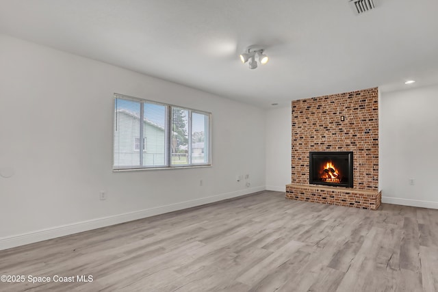 282 Hollywood Blvd, Melbourne, FL 32904 - unfurnished living room with a fireplace and light wood-type flooring