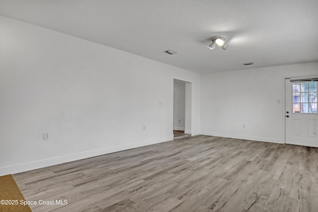 282 Hollywood Blvd, Melbourne, FL 32904 - empty room featuring a textured ceiling and light wood-type flooring