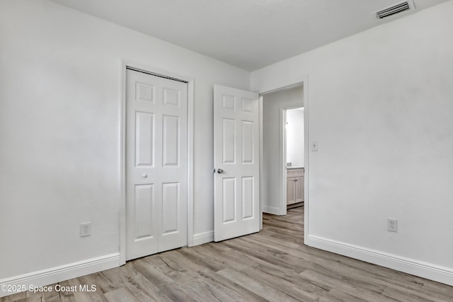 282 Hollywood Blvd, Melbourne, FL 32904 - unfurnished bedroom featuring a closet and light wood-type flooring