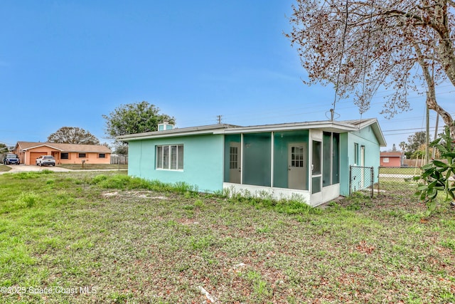 282 Hollywood Blvd, Melbourne, FL 32904 - rear view of house with a lawn and a sunroom